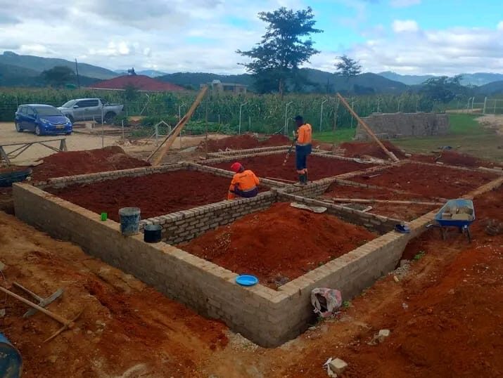 Foundation and walling in progress with workers on site
